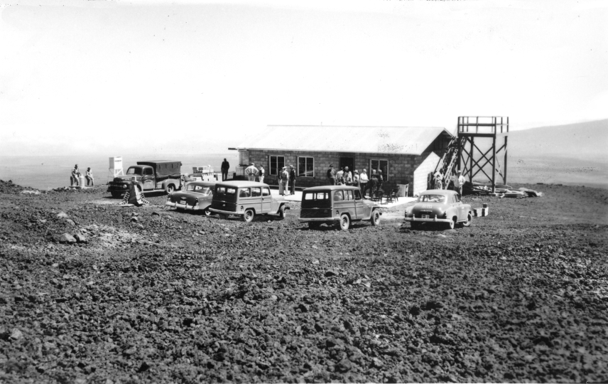 A black and white photo of the Mauna Loa Observatory in Hawaii, under construction in 1956.