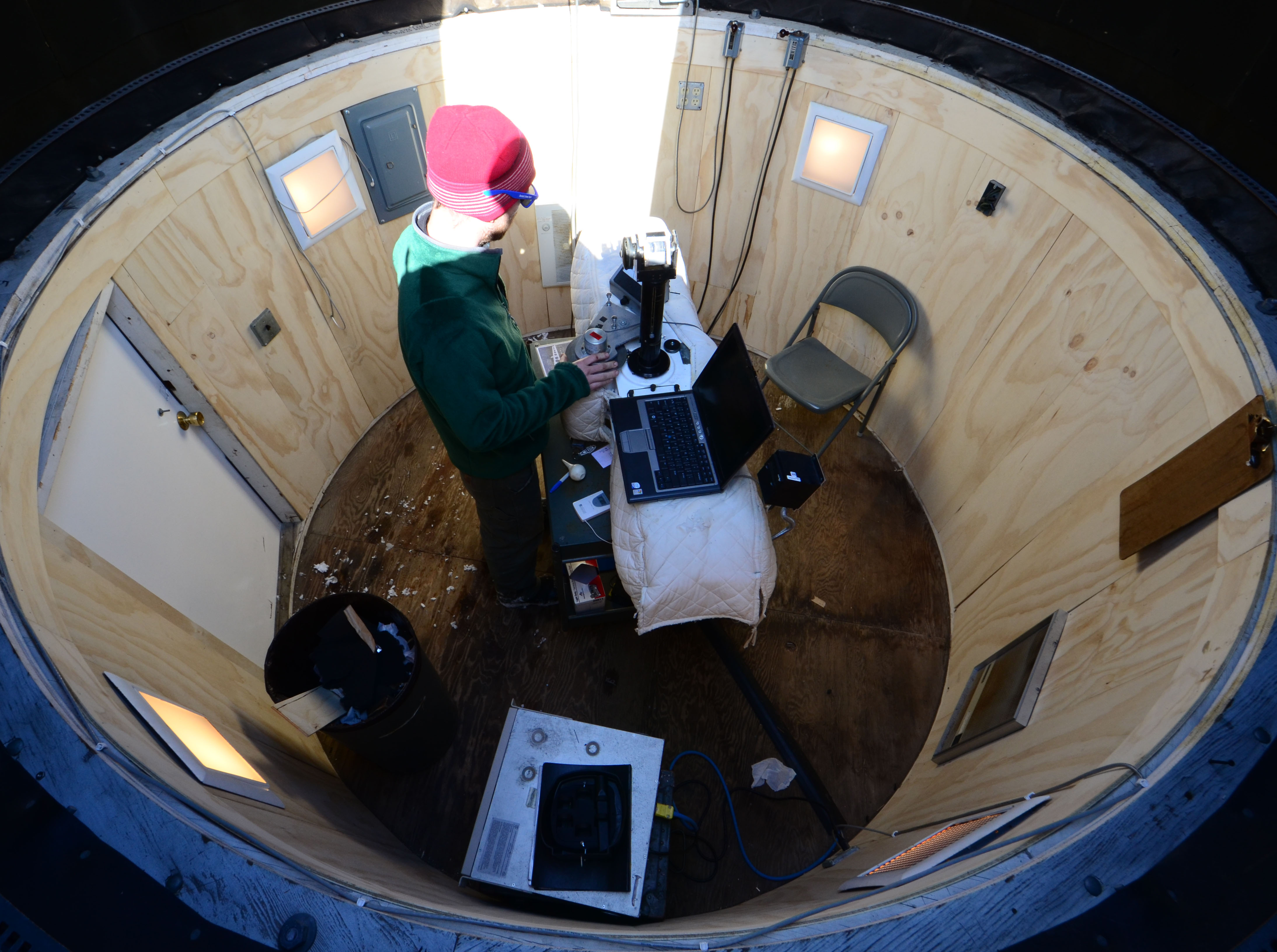 In the Dobson Dome, NOAA technician Marty Martinsen observes the amount of ozone in the atmosphere. Sunlight is required for the spectrophotometer to measure ozone.