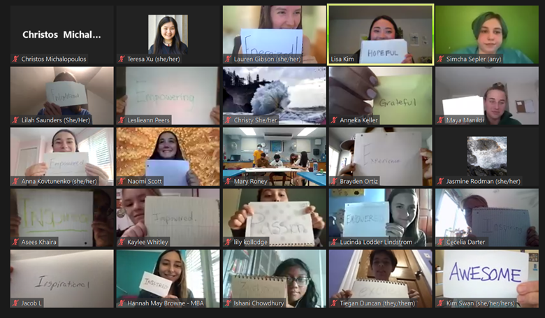 Screenshot of teens and NOAA staff in a video meeting holding up pieces of paper with words written on them. Words include energized, hopeful, empowering, enlightened, grateful, inspired, inspirational, and awesome.