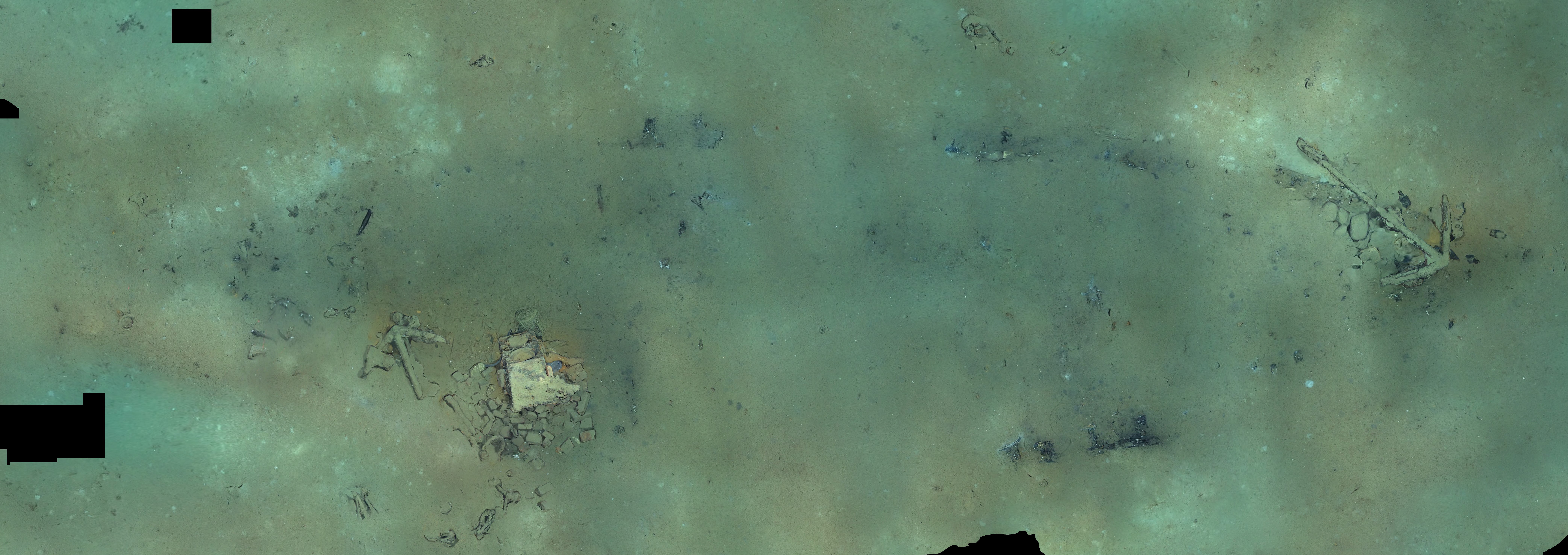 The mosaic of images from the NOAA video of the brig Industry shipwreck in the Gulf of Mexico, February 25, 2022, shows the outline in sediment and debris of the wooden hull of the 64-foot by 20-foot whaling brig. The tryworks and two anchors are also visible. A third anchor is buried in the sediment near the tryworks. Mosaic was created by the Bureau of Ocean Energy Management using NOAA ROV video footage.