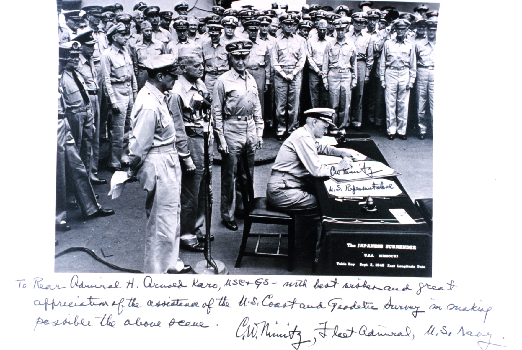 Admiral Chester Nimitz signing the Japanese surrender document with a personal note and signature below, which reads, "To Rear Admiral H. Arnold Karo, USC&GS - with best wishes and great appreciation of the assistance of the U.S. Coast and Geodetic Survey in making possible the above scene. C.W. Nimitz, Fleet Admiral, U.S. Navy.”