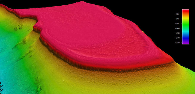 This image is a composite of multibeam sonar data collected by NOAA Ship Nancy Foster of a large shallow area (red colors) full of coral on the east end of St. Croix in the U.S. Virgin Islands. It abruptly drops off into surrounding deep water (yellows and greens). Black areas are where no data was collected by the sonar. The island of St. Croix would be above and to the left of the image. 