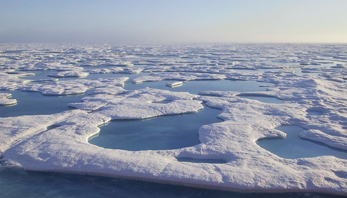 During summer months when temperatures peak, "melt ponds" form over the surface of Arctic ice shelves. These pools of water can reflect radiation from the sun back into the atmosphere, which can amplify the impacts of warming. 