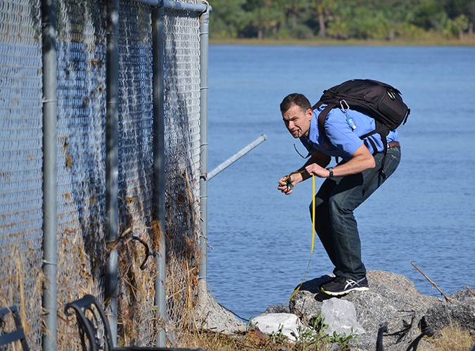 Oct. 15, 2016- NHC storm surge team leader Jamie Rhome assesses the debris line along a fence at Ft. Pulaski near Savannah, Georgia., to help determine the height of Matthew’s storm surge. 