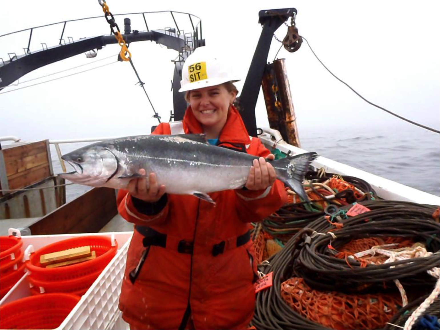 Kate Dubickas during her June 2012 NOAA Hollings internship with the Southwest Fisheries Science Center Fisheries Ecology Division. Here she stands aboard the R/V Ocean Starr, somewhere in the California Current off the coast of Northern California, holding a Chinook salmon.