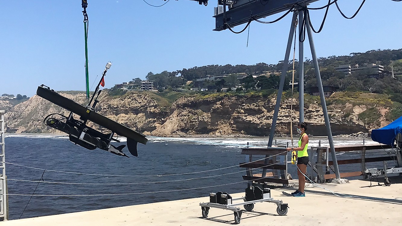 Sophia Merrifield deploys a wave glider from the Scripps Institution of Oceanography pier in San Diego, Calif.
