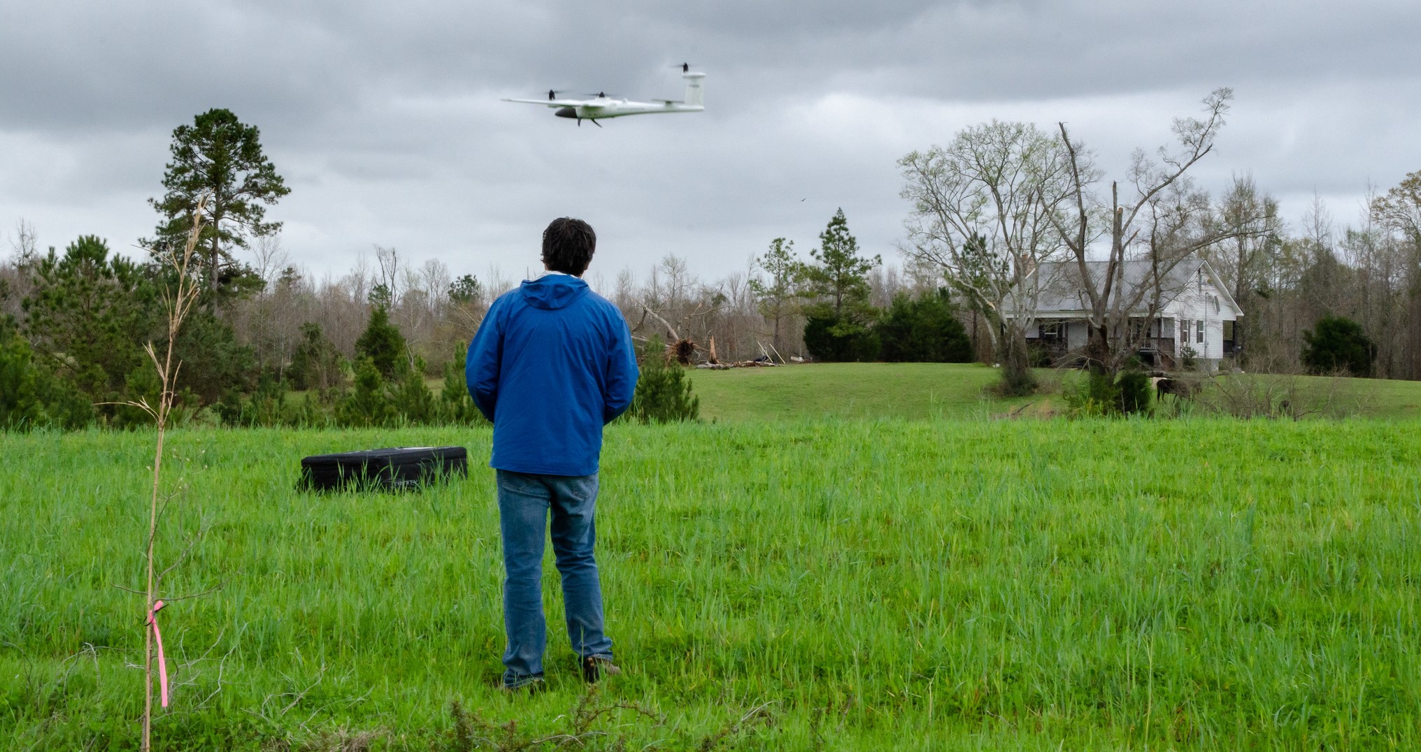 A researcher with the NOAA National Severe Storms Laboratory flies a drone near tornado damage in Alabama in April 2021. Scientists hope aerial images of tornado paths of destruction can better characterize high-wind damage to vegetation and in rural areas to improve disaster response and recovery.