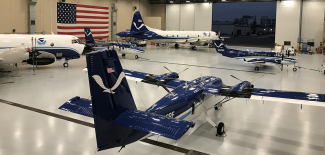 NOAA Aircraft Operations Center Hangar (Lakeland, Florida) interior showing two Twin Otters, two WP-3Ds and a  King Air on January 3, 2020. 