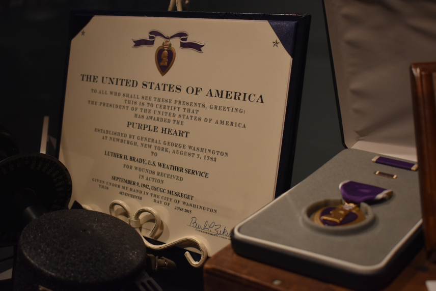Purple heart medal and certificate rest in a display case as part of the Treasures of NOAA's Ark exhibit at the Tellus Science Museum in Cartersville, GA.