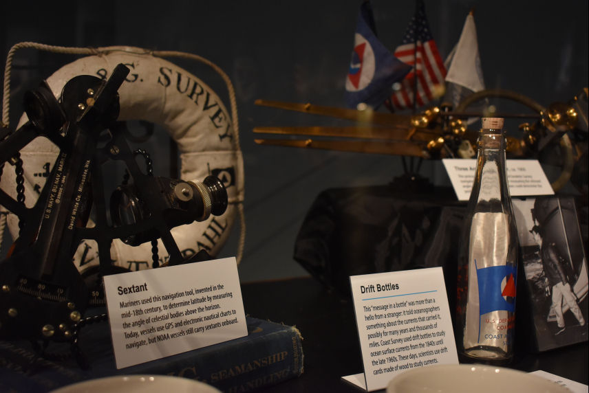 Surveying equipment, including a sextant, floatation device, and drift bottle, on display as part of the Treasures of NOAA's Ark exhibit at the Tellus Science Museum in Cartersville, GA.