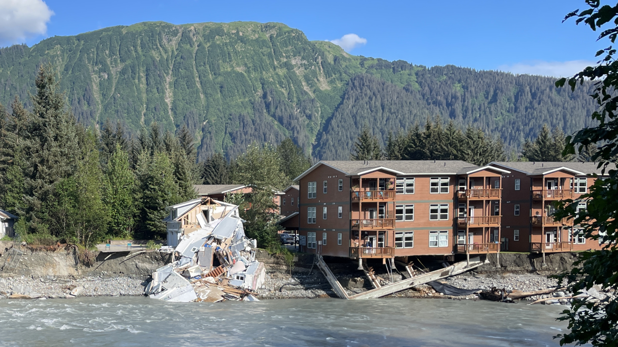 Homes along the Mendenhall River near Juneau, Alaska, were damaged and the river bank eroded during unprecedented flooding in August 2023, caused when a glacial lake on a tributary burst through an ice dam. Climate warming has led in increasing extreme weather events in Alaska and the Arctic. Credit: Aaron Jacobs/ NOAA National Weather Service.