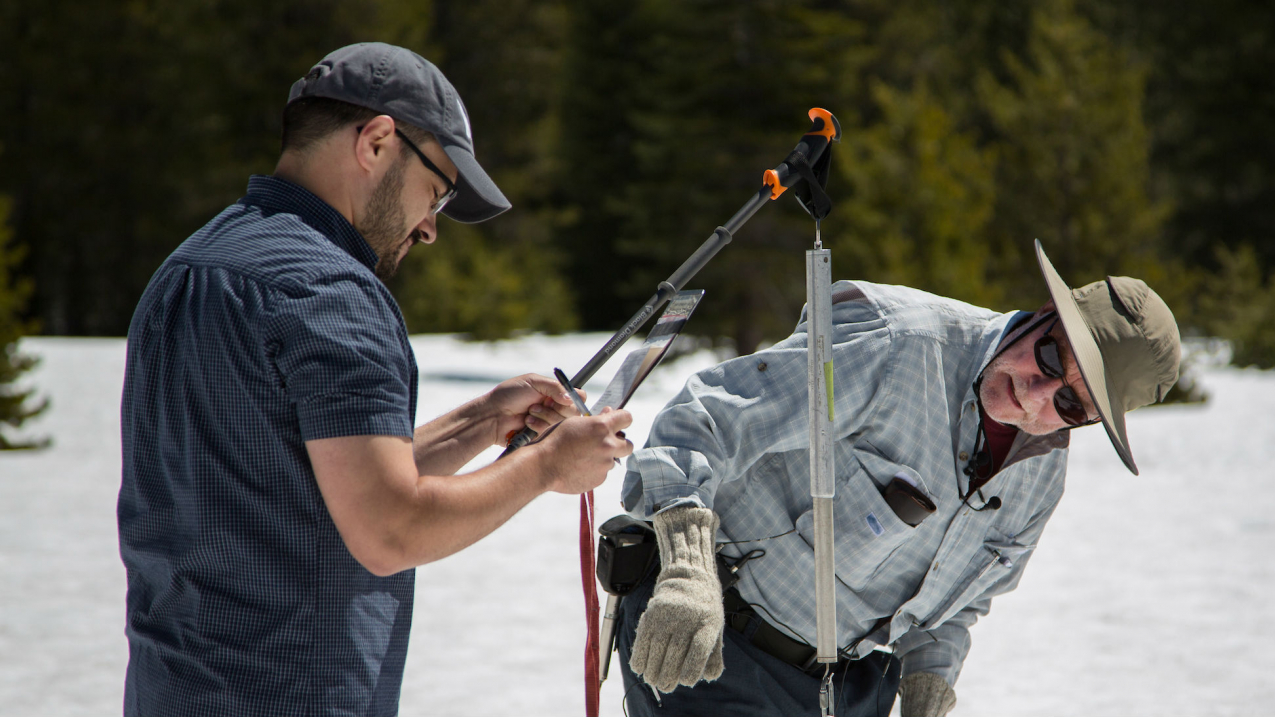 Frank Gehrke (right), chief of the California Cooperative Snow Surveys Program and Wes McCandless (left) conduct the final snow survey at Phillips Station in the Sierra Nevada Mountains in Northern California. 