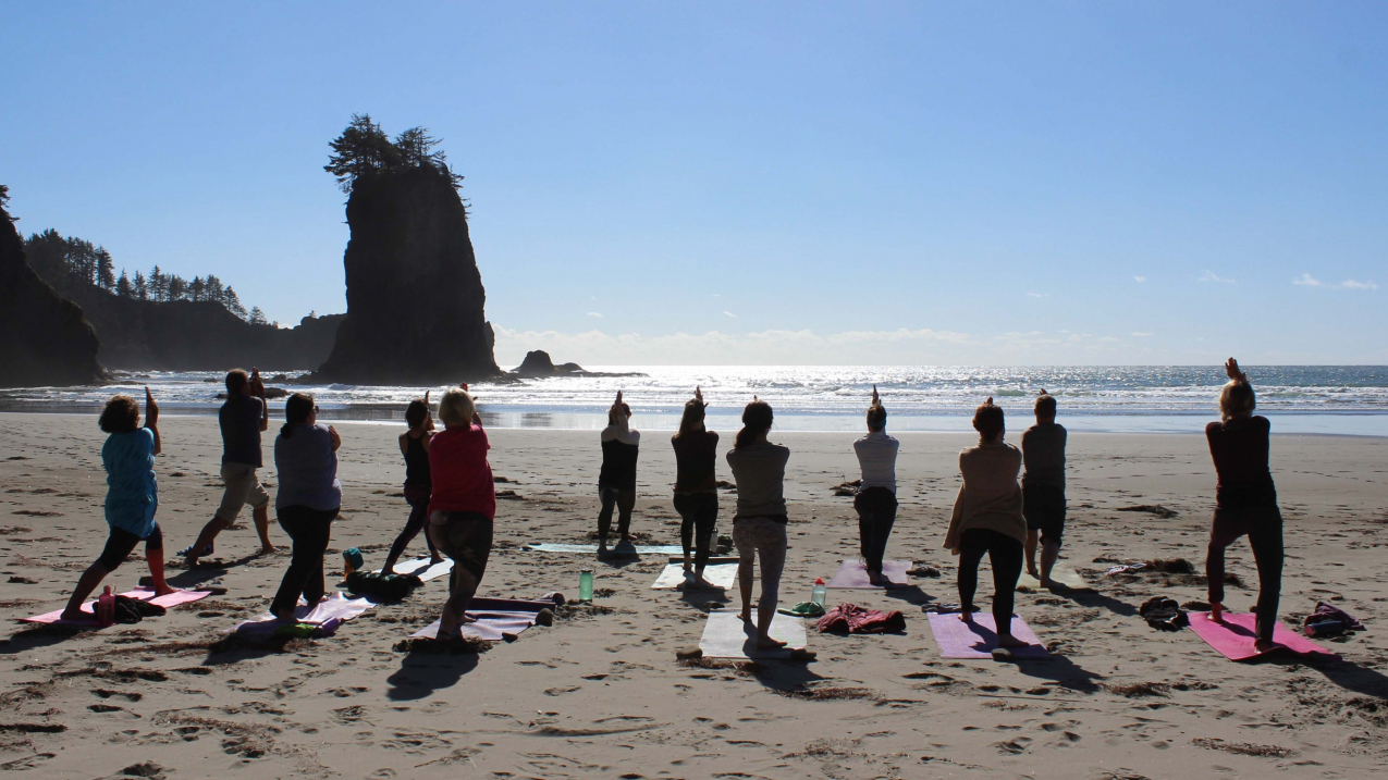 Visitors practice yoga with a view of the Olympic Coast National Marine Sanctuary.