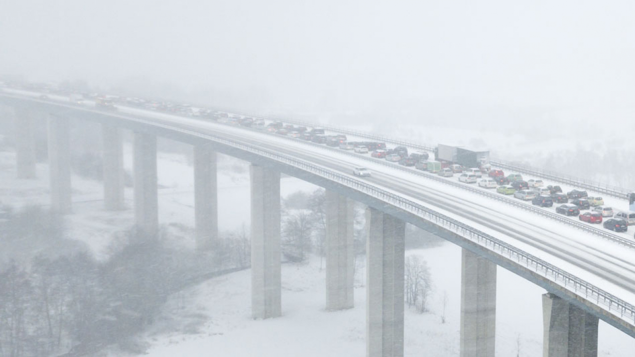 Highway bridge during a heavy snowfall.