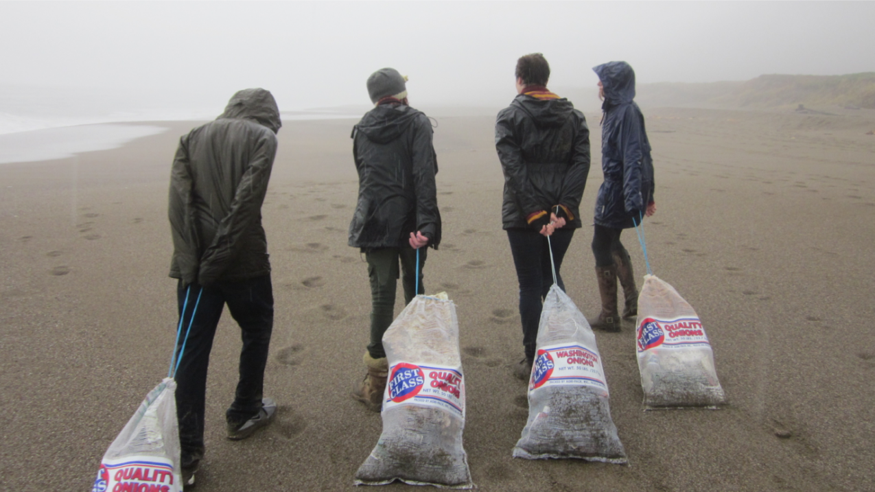 Students at Sir Francis Drake High School collect bags of marine debris that washed ashore on Point Reyes Beach in northern California.