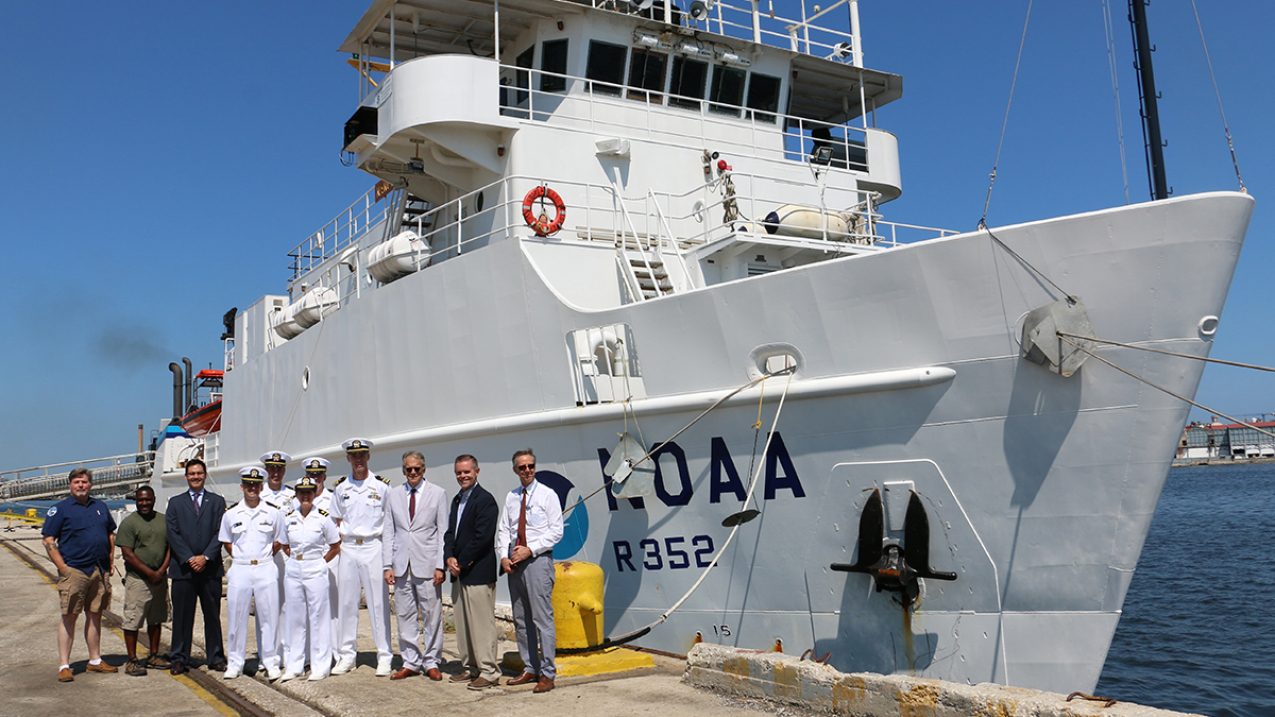 U.S. Charge d'Affaires Jeffrey DeLaurentis, U.S. Embassy personnel, and crew members from NOAA Ship Nancy Foster pause for a photo May 9, 2016, with the ship during its visit to Havana, Cuba.