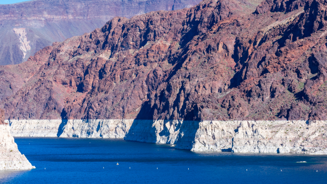 A white "bathtub ring" exposes the former waterline in Lake Mead during low water levels in July 2021. 