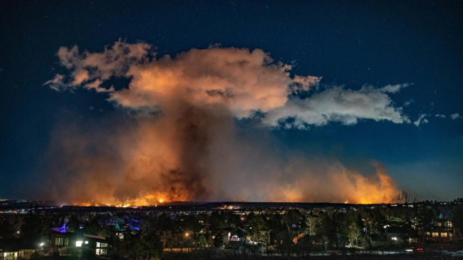 Night falls as the Marshall Fire continues to burn through Louisville ( left) and Superior (right). 