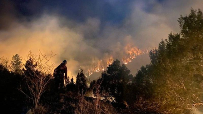Firefighters conduct firing operations during New Mexico's Hermits Peak fire on May 9, 2022. The Hermits Peak Fire is the largest in New Mexico's history.
