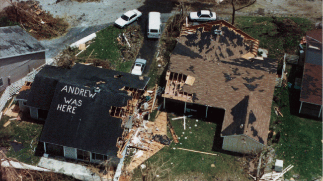 House destroyed by Hurricane Andrew that says "Andrew was here" on the roof.