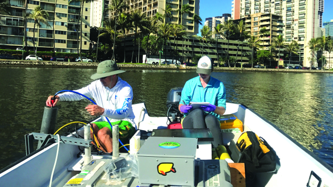 A team from Hawaii Sea Grant samples water quality in the Ala Wai Canal off Honolulu, Hawaii.