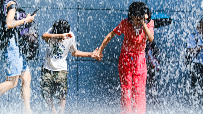Children playing in a water fountain during a heat wave on July 24, 2023, in Hong Kong, China. Asia, Africa and South America all sweltered through their hottest Julys on record last month.