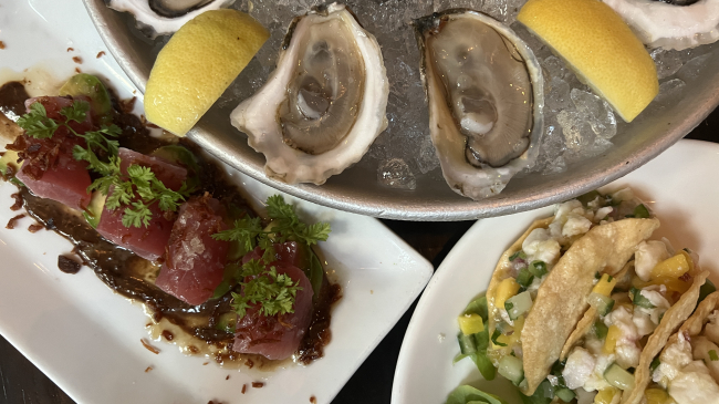A seafood platter of tuna crudo, halibut-ceviche tacos, and Eastern oysters. 