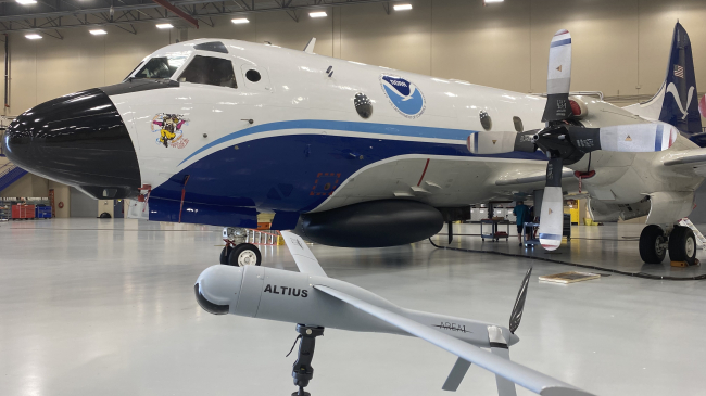 The Altius-600 uncrewed aircraft system demonstration model appears with Hurricane Hunter NOAA WP-3D Orion, known as “Miss Piggy,” at NOAA’s Aircraft Operations Center in Lakeland, Florida, during an uncrewed aircraft system flight test on May 25, 2022. 