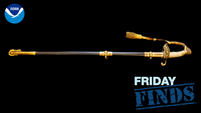 Photo of Nicholas H. Heck’s USN ceremonial sword on a black background with the NOAA logo in the upper left corner and the Friday Finds graphic in the lower right corner.