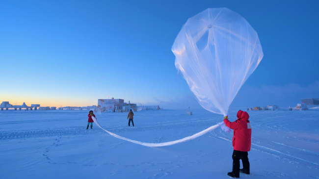 NOAA scientists launch a weather balloon carrying an ozonesonde at the South Pole on October 1, 2023.