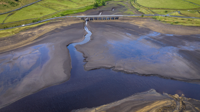 July 3, 2023: An aerial view of low water levels at Woodhead Reservoir in Glossop, England, after the United Kingdom sweltered through its hottest June on record. 2023 was the world’s warmest year on record, beating the next warmest year (2016) by a record-setting margin of 0.27 of a degree F (0.15 of a degree C).
