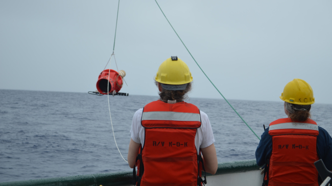 Photo showing NOAA Affiliates Dr. Elizabeth Steffen (left) and Marine Tech Elizabeth Ricci (right) deploy a Deep Sounding Oceanographic Lagrangian Observer (SOLO) Argo float from the R/V Kaʻimikai-O-Kanaloa in 2018.