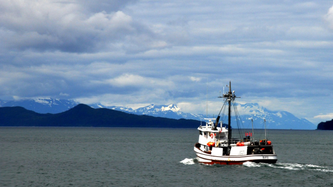 A fishing boat out on open sea in Alaska. 