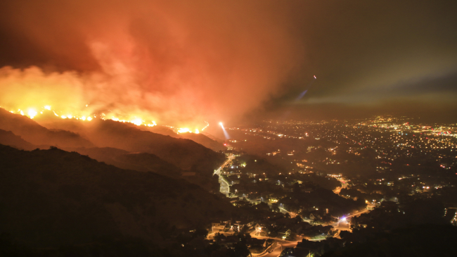 Wildfires and heavy rains are specific types of weather events that can be made more extreme by climate change, say scientists in research published December 2019 in a special edition of the Bulletin of the American Meteorological Society. In this photo, a wildfire rages in the hills of the Los Angeles area. (2017 stock image.)