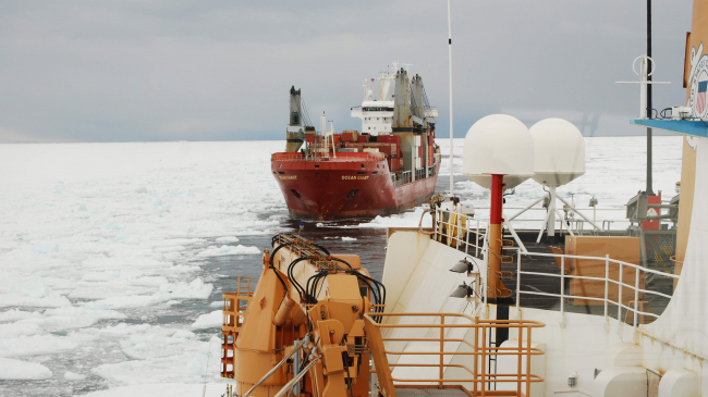 The U.S. Coast Guard Cutter Polar Star leads the way cutting a channel, so that the container and supply ships can make it through the ice. 