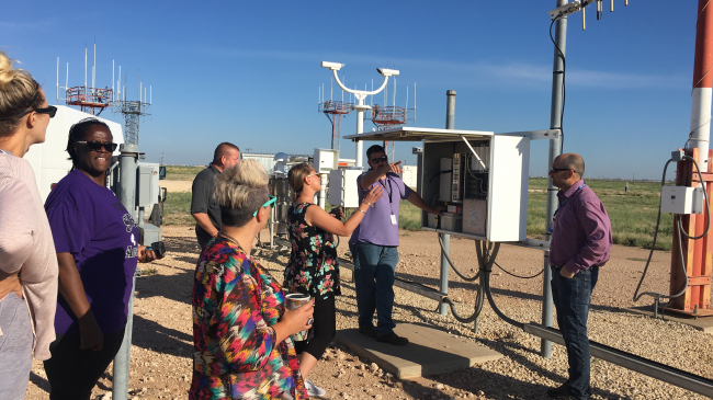 During a workshop, electronics systems analyst Charles Yaws and electronics technicians Kris Harrison and Danny Reed at the Weather Forecast Office in Midland, Texas, show teachers around a local automated surface observing station.