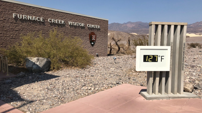 Death Valley National Park set a new world record in July 2018: It was the hottest place during hottest month on record. Temperatures reached 127 degrees F for four days in a row (as shown in this photo of a temperature sign in front of the park's visitor center), and the park experienced an average monthly temperature of 108 degrees for July. Learn more at https://www.nps.gov/deva. 