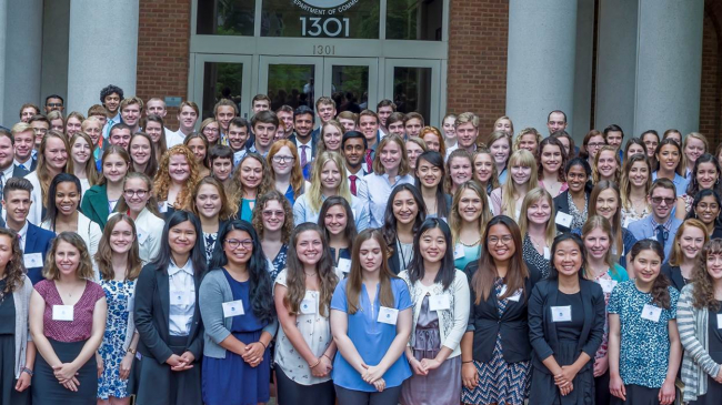 A group photo of over 100 college-aged NOAA scholars taken outside of the NOAA headquarters office.