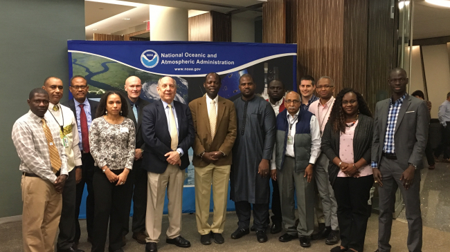 NOAA National Weather Service Director Louis Uccellini (center, sixth from the left) celebrates the 25th anniversary of the African Desk, an important part of NOAA's Climate Prediction Center (CPC), alongside colleagues from across CPC and partners from around the globe.