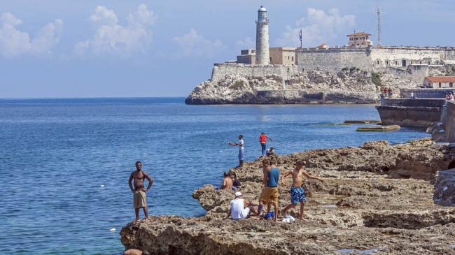 Teenagers swimming near Moro Castle, Havana, Cuba 