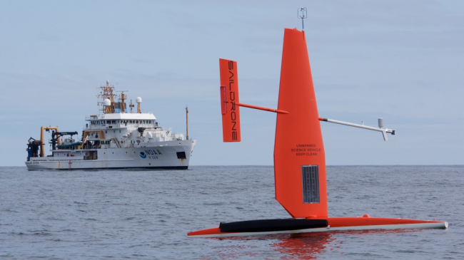 A Saildrone, seen with the NOAA Ship Oscar Dyson, studies ocean conditions.