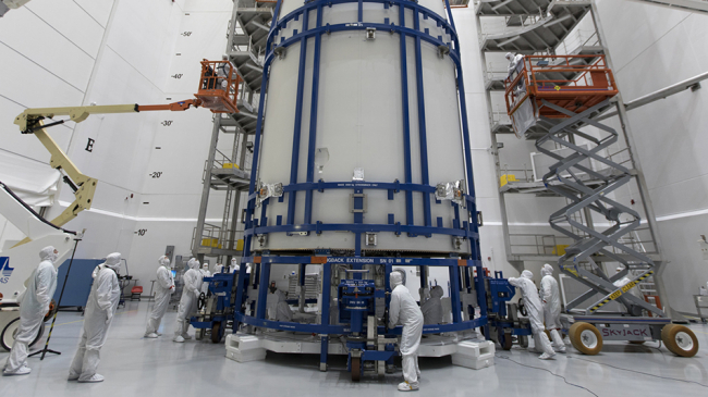 In a clean room at Astrotech Space Operations in Titusville, Florida, technicians and engineers monitor progress as NOAA's GOES-S satellite is encapsulated in its payload fairing. 
