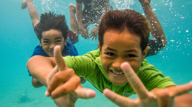 Children swim in National Marine Sanctuary of American Samoa.