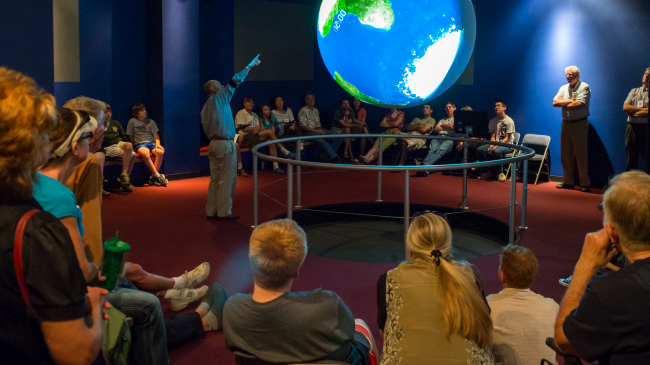 Science On a Sphere® (SOS) is a global display system that uses computers and video projectors to display planetary data onto a six-foot diameter sphere, a giant animated globe. Developed by NOAA researchers, these globes are now in more than 100 museums and science institutions around the world. 