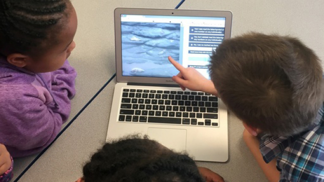 Second graders from an elementary school in Memphis, Tennessee work together to classify images on Steller Watch, a citizen science project in which volunteers review images of Steller sea lions from the remote Aleutian Islands. 