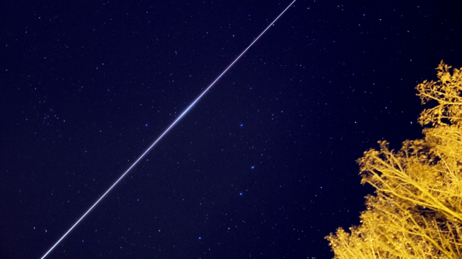 This time lapse image, taken on January 10, 2008, shows the International Space Station crossing the night sky.