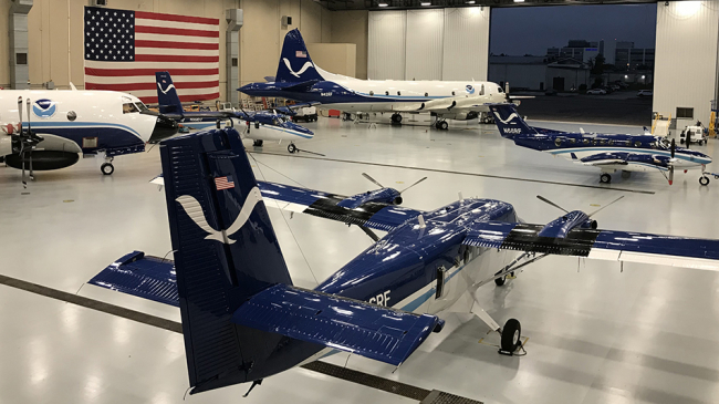 NOAA Aircraft Operations Center Hangar (Lakeland, Florida) interior showing two Twin Otters, two WP-3Ds and a  King Air on January 3, 2020. 