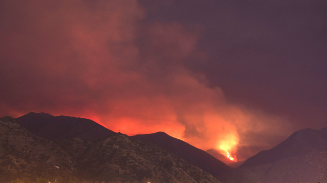 A wildfire burns above the city of Azusa, California. August 19, 2020.