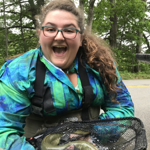 Blair Morrison holding an American eel during her internship with Wells National Estuarine Research Reserve in Maine. 
