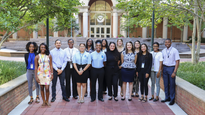 The NOAA Educational Partnership Program with Minority Serving Institutions Undergraduate Scholarship Classes of 2018 and 2019 stand together outside NOAA headquarters in Silver Spring, Maryland.